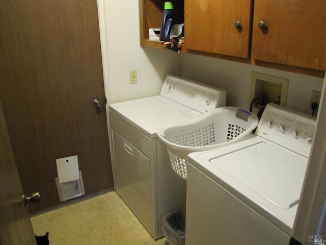 laundry room featuring cabinets and washing machine and dryer