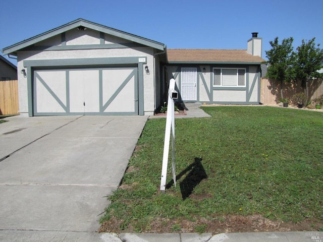 view of front of property featuring a garage and a front lawn