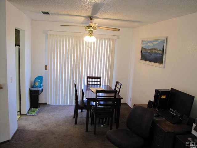 dining space with ceiling fan, a textured ceiling, and carpet