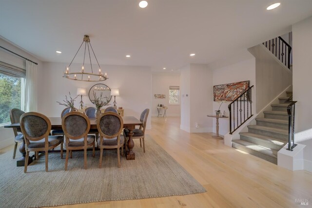 living room with a fireplace, crown molding, and light wood-type flooring