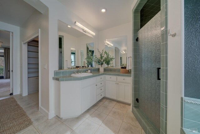 kitchen with a kitchen island, pendant lighting, white cabinetry, light stone countertops, and built in refrigerator