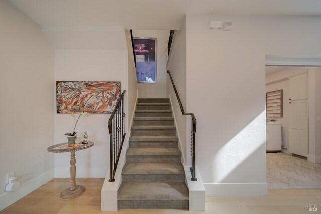 carpeted bedroom with an inviting chandelier, access to exterior, and vaulted ceiling with beams