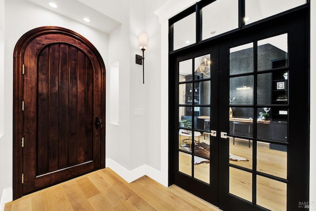 entrance foyer featuring french doors and hardwood / wood-style flooring