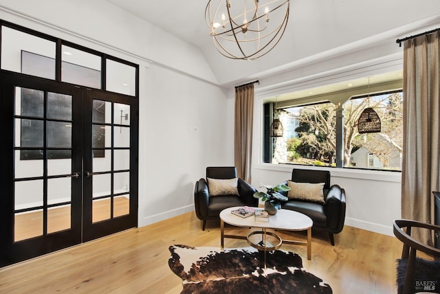 sitting room featuring hardwood / wood-style flooring, plenty of natural light, lofted ceiling, and french doors