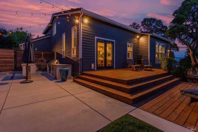 back of property with a yard and a wooden deck