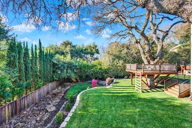 view of yard featuring a wooden deck