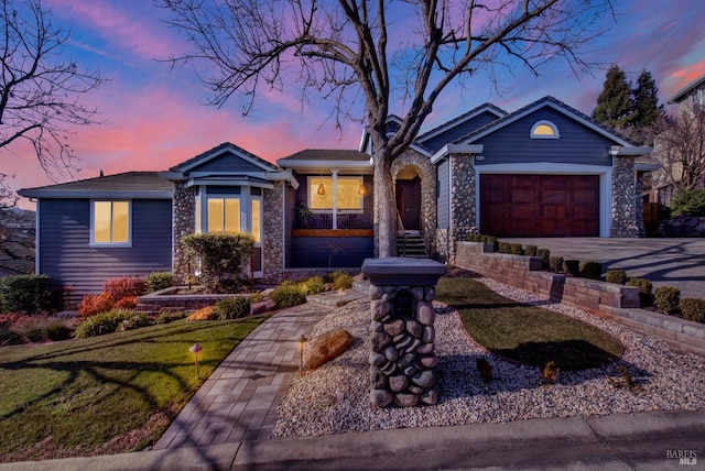 ranch-style house featuring a garage and a lawn