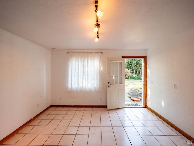 foyer entrance with light tile patterned flooring