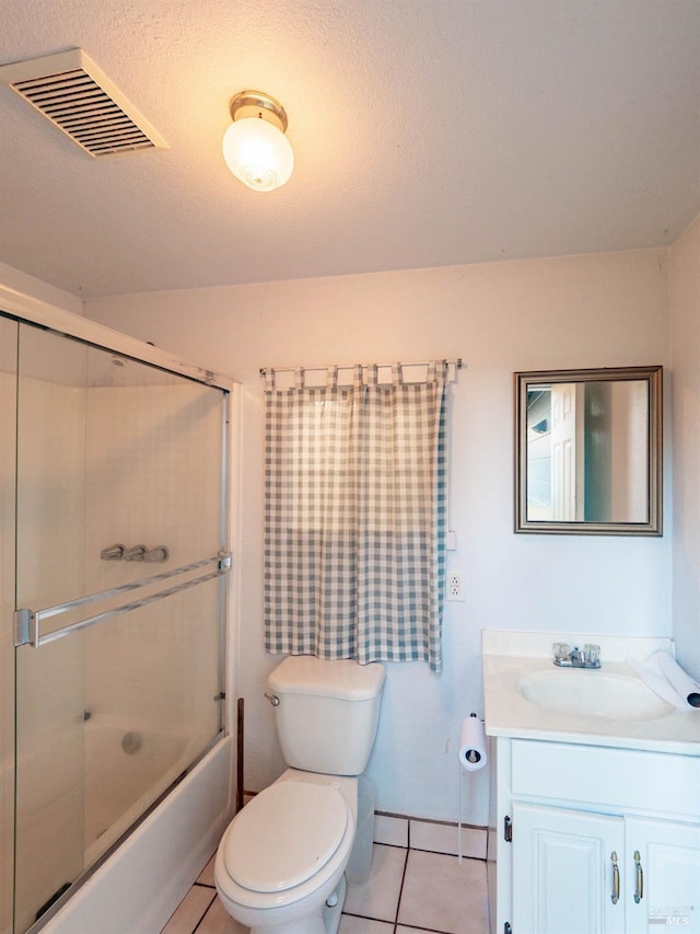 full bathroom featuring toilet, combined bath / shower with glass door, tile patterned floors, and vanity