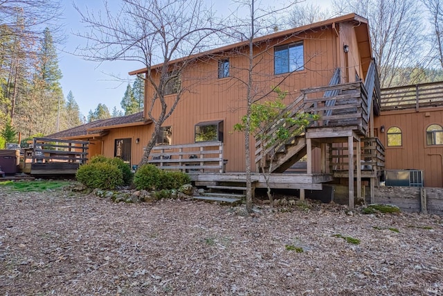 back of house with a deck and cooling unit