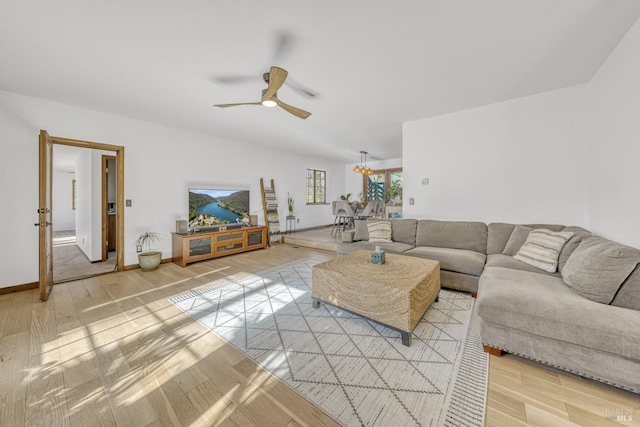 unfurnished living room featuring ceiling fan and light wood-type flooring