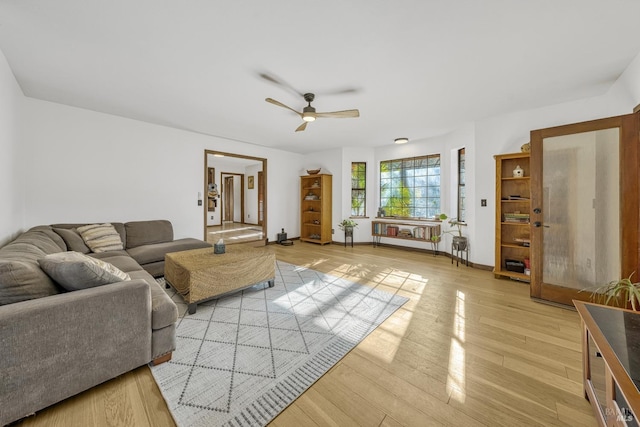 living room with light hardwood / wood-style floors and ceiling fan