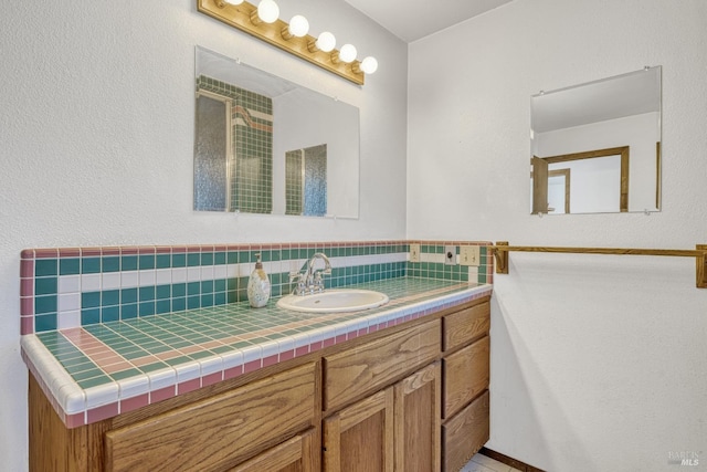 bathroom featuring vanity and tasteful backsplash