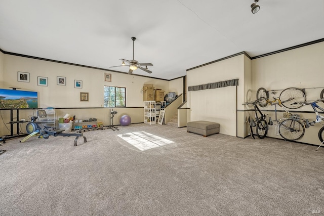 interior space with ceiling fan, light colored carpet, and ornamental molding