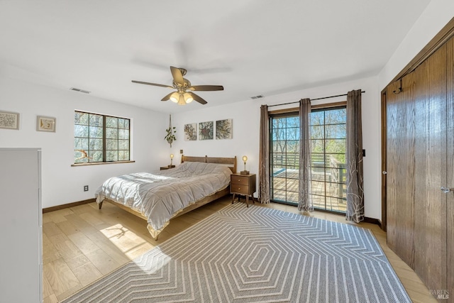 bedroom featuring light wood-type flooring, ceiling fan, and access to outside