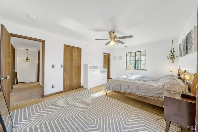 bedroom with light wood-type flooring and ceiling fan