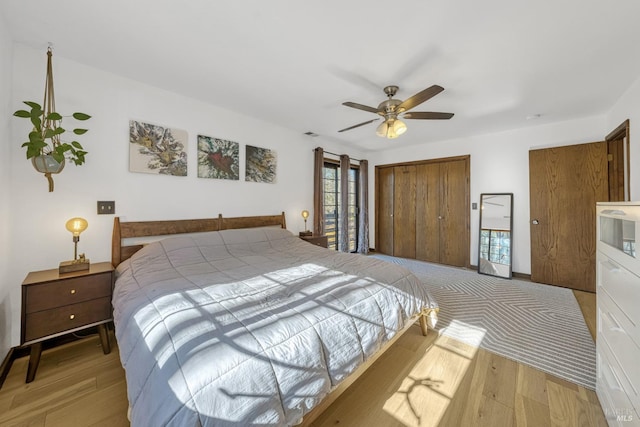 bedroom with ceiling fan, a closet, and light hardwood / wood-style floors