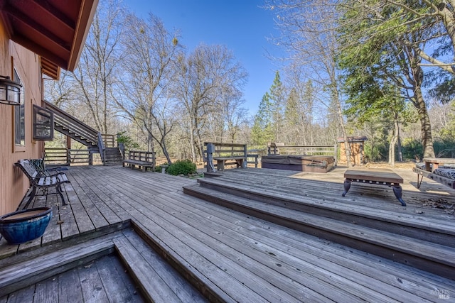 wooden deck featuring a covered hot tub