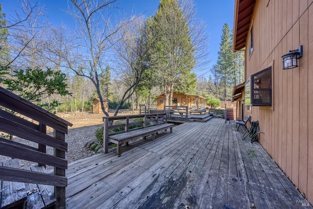 wooden deck featuring a storage shed