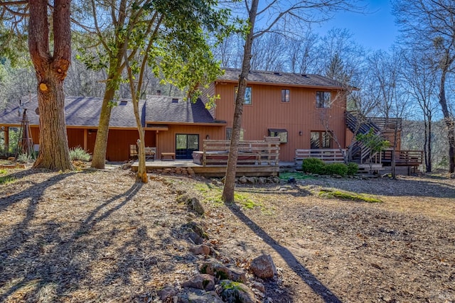 rear view of property featuring a wooden deck