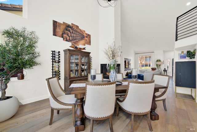 dining area featuring a high ceiling and hardwood / wood-style floors