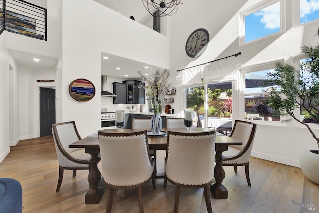 dining room featuring a high ceiling and wood-type flooring