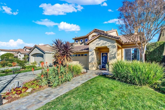 mediterranean / spanish-style home with a garage and a front lawn