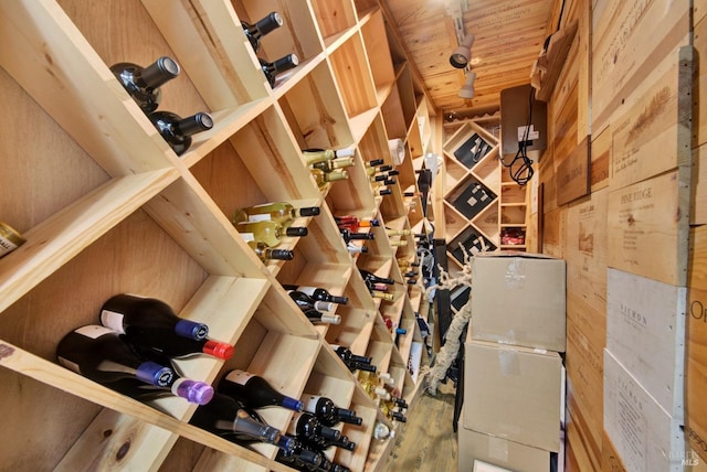 wine area with wooden ceiling and wood walls