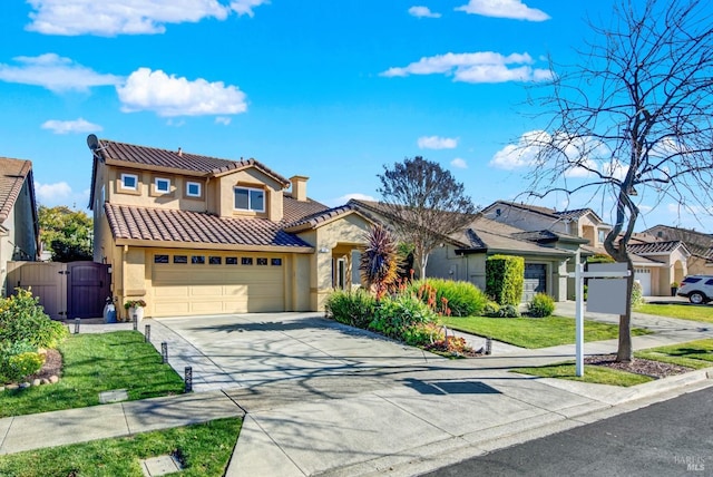 mediterranean / spanish-style house featuring a garage and a front yard