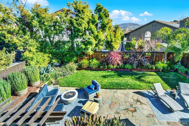 view of patio / terrace featuring a mountain view and a fire pit