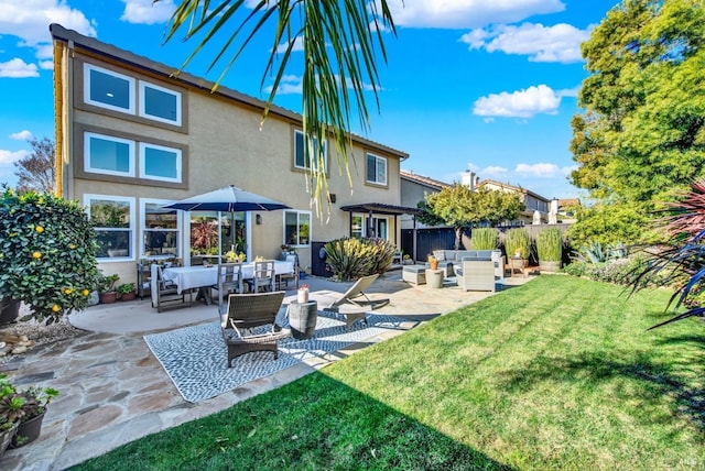 back of house featuring a pergola, a patio area, an outdoor hangout area, and a lawn