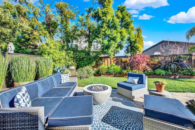 view of patio featuring an outdoor living space with a fire pit