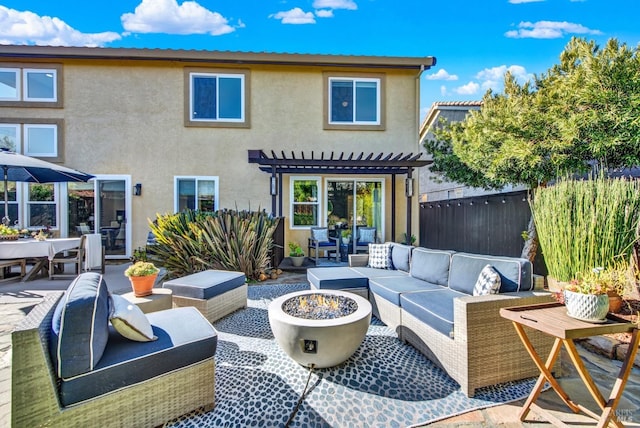 back of house featuring a pergola, an outdoor living space with a fire pit, and a patio area