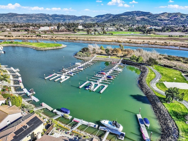 drone / aerial view with a water and mountain view