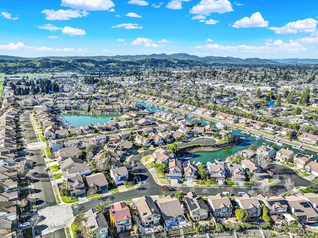 birds eye view of property featuring a water and mountain view