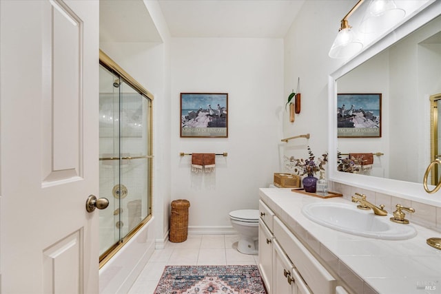 full bathroom featuring vanity, toilet, bath / shower combo with glass door, and tile patterned flooring