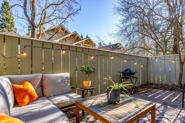 view of patio / terrace with a deck and a grill