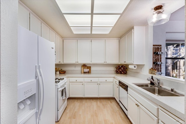 kitchen featuring sink, white appliances, white cabinetry, and light hardwood / wood-style flooring