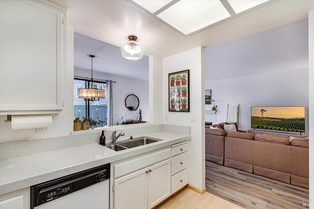 kitchen featuring sink, dishwasher, white cabinets, and light hardwood / wood-style floors