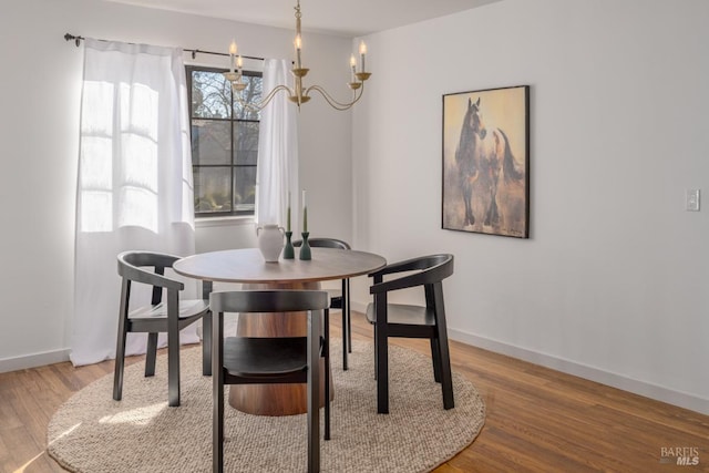 dining area with an inviting chandelier and hardwood / wood-style floors