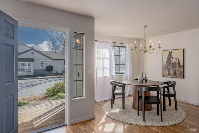 dining room with wood-type flooring and a chandelier