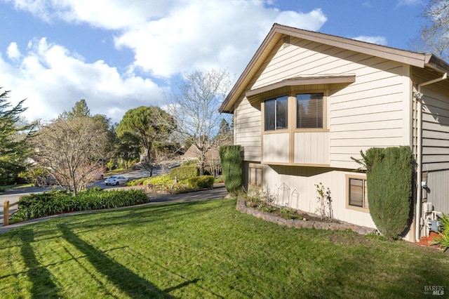 view of side of home featuring a yard