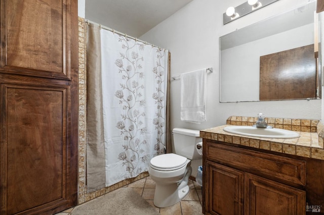 bathroom featuring tile patterned floors, vanity, and toilet