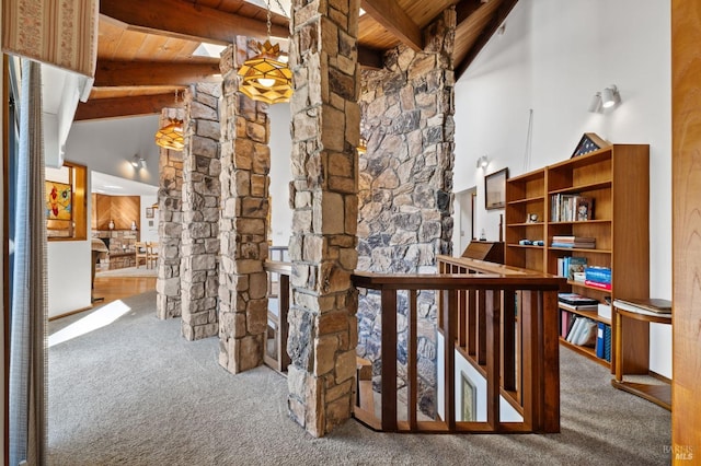 hall with wooden ceiling, carpet floors, beamed ceiling, and high vaulted ceiling