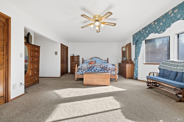 bedroom featuring ceiling fan and carpet