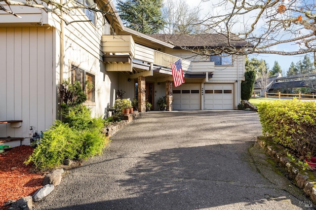 view of front of home with a balcony and a garage