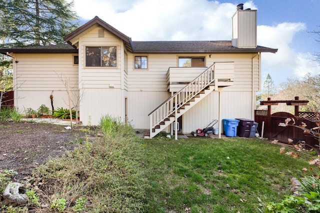 rear view of property featuring a yard