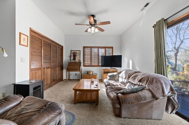 carpeted living room with ceiling fan and a wealth of natural light