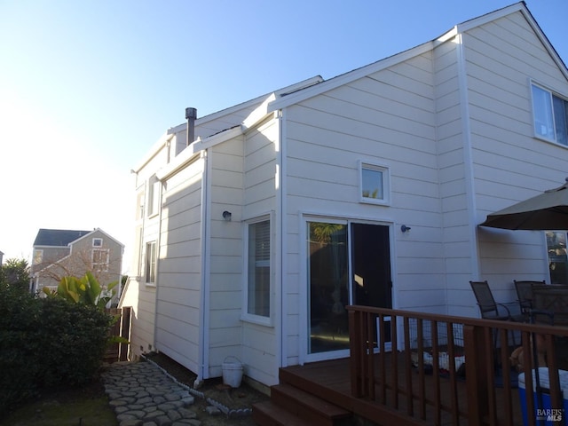 back of house with a wooden deck