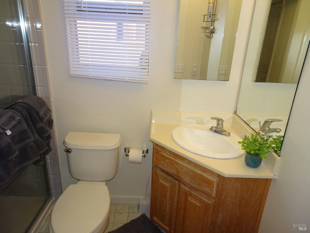 bathroom featuring vanity, toilet, and an enclosed shower